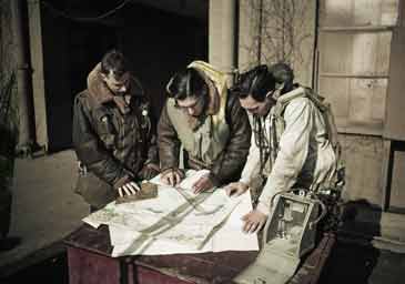 Royal Air Force bomber crew plotting a course on a map before a raid